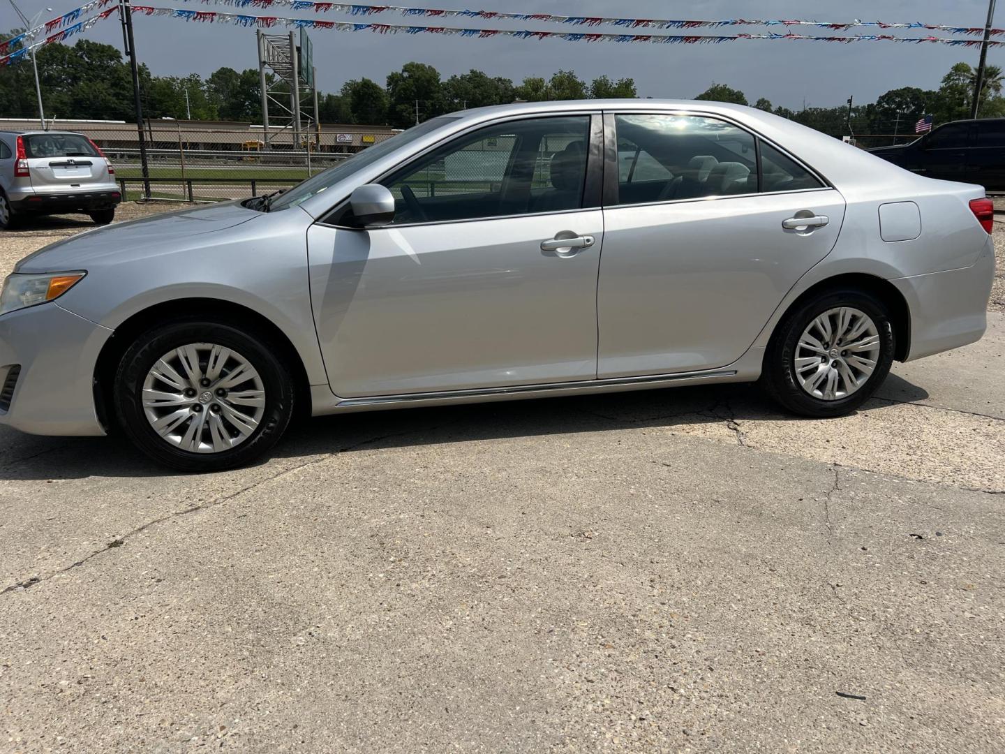 2014 Silver /Gray Toyota Camry LE (4T1BF1FK9EU) with an 2.5L L4 DOHC 16V engine, 6-Speed Automatic transmission, located at 4520 Airline Hwy, Baton Rouge, LA, 70805, (225) 357-1497, 30.509325, -91.145432 - 2014 Toyota Camry LE 2.5L 4 Cylinder Gas Saver, 182K Miles, Automatic, Bluetooth Radio, Cold A/C, Power Windows, Locks & Mirrors, Seating For 5. Always Serviced At Toyota Dealer. FOR INFO PLEASE CONTACT JEFF AT 225-413-0981. CHECK OUT OUR A+ RATING WITH THE BETTER BUSINESS BUREAU. WE HAVE BEEN A FA - Photo#1